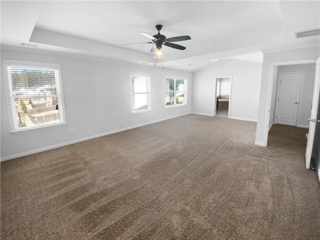 interior space with carpet floors, a raised ceiling, visible vents, and baseboards