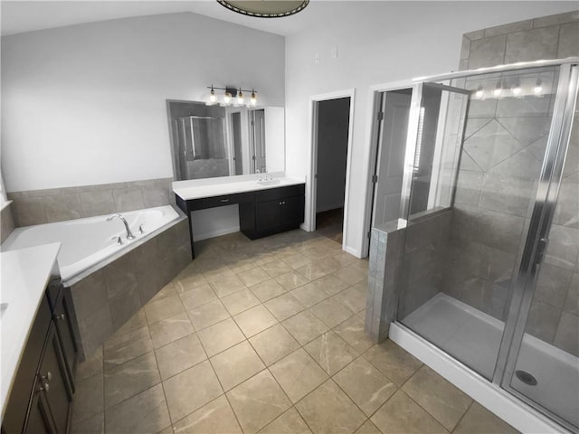 full bath with a garden tub, vaulted ceiling, a shower stall, vanity, and tile patterned floors