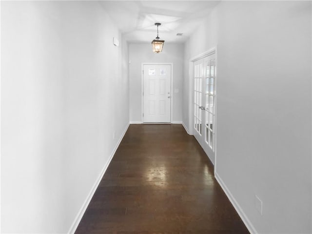 doorway to outside featuring dark wood-type flooring, french doors, and baseboards