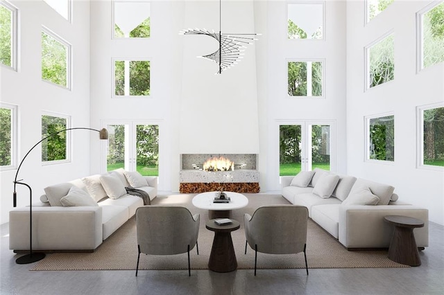 interior space featuring french doors, a healthy amount of sunlight, and a lit fireplace