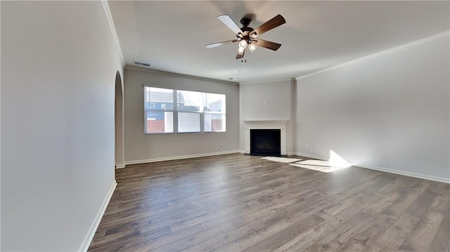 unfurnished living room with ceiling fan, ornamental molding, and wood-type flooring