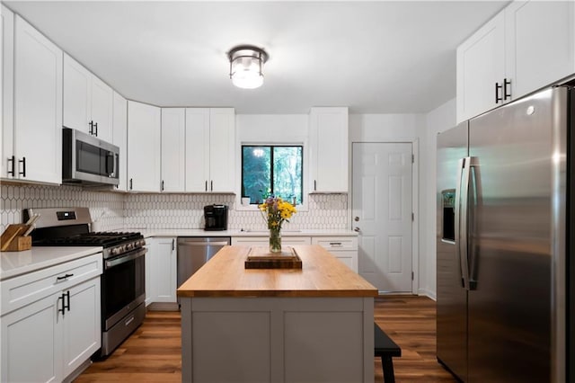 kitchen featuring white cabinets, stainless steel appliances, and a kitchen island