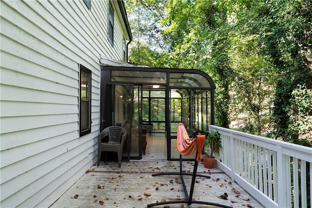 wooden deck featuring a sunroom