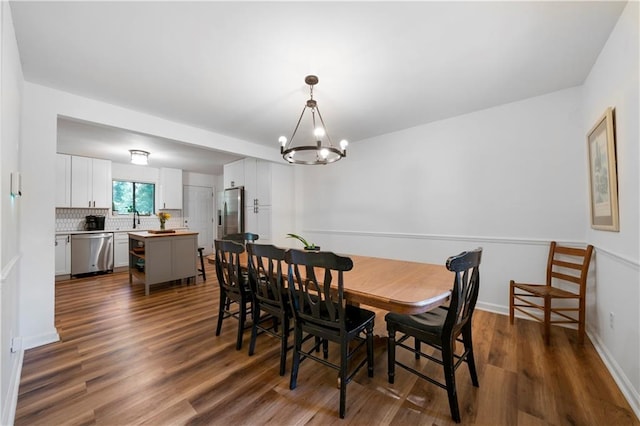 dining area featuring dark hardwood / wood-style floors and a notable chandelier