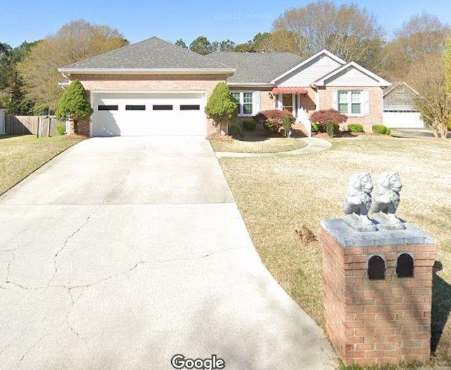 ranch-style house featuring a garage and a front yard