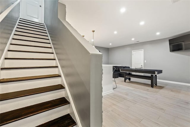 stairway with hardwood / wood-style flooring