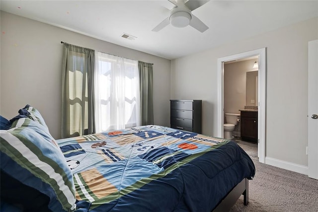 bedroom with carpet flooring, ensuite bathroom, and ceiling fan