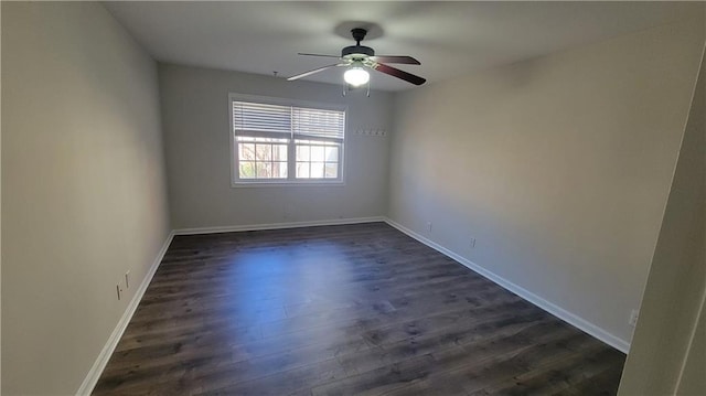 empty room with a ceiling fan, dark wood-style flooring, and baseboards