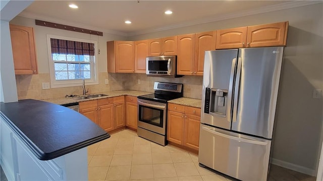 kitchen featuring stainless steel appliances, backsplash, ornamental molding, light brown cabinets, and a sink