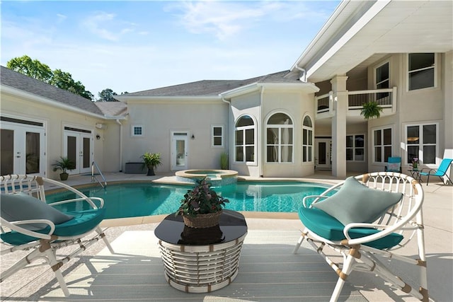 view of swimming pool with a patio area, an in ground hot tub, and french doors