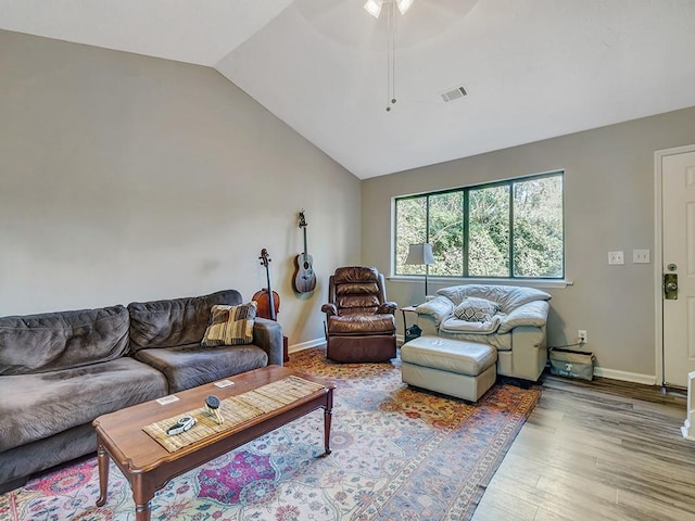 living room featuring vaulted ceiling and hardwood / wood-style floors