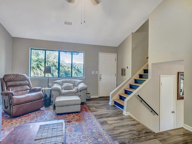 living room featuring wood-type flooring and ceiling fan