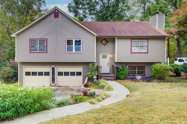 split foyer home featuring a garage and a front yard