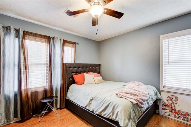 bedroom with hardwood / wood-style flooring and ceiling fan