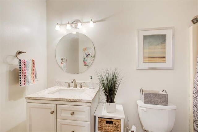 bathroom with toilet and vanity