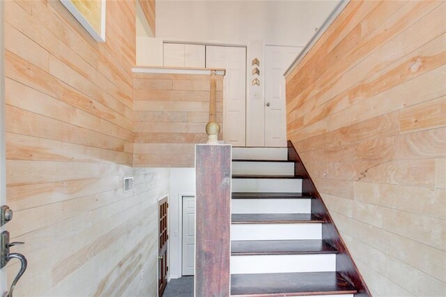 stairway with wood walls