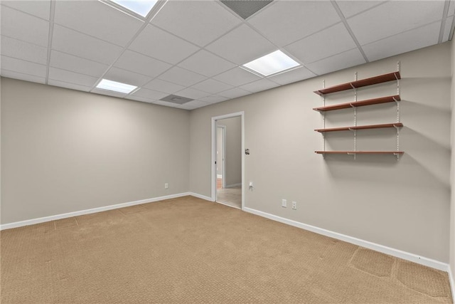 basement with a drop ceiling and carpet floors