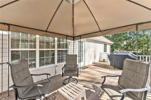 deck with a grill and a gazebo