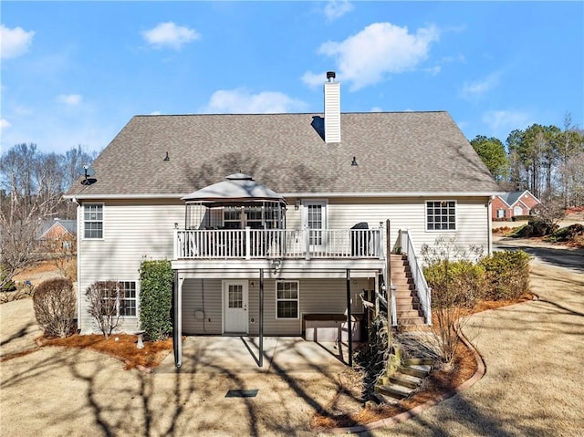 back of property featuring a gazebo, a deck, and a patio area