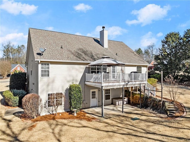 back of property featuring a gazebo, a patio area, and a deck