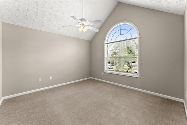 spare room featuring ceiling fan, light colored carpet, vaulted ceiling, and a textured ceiling