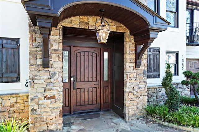 view of exterior entry featuring stone siding