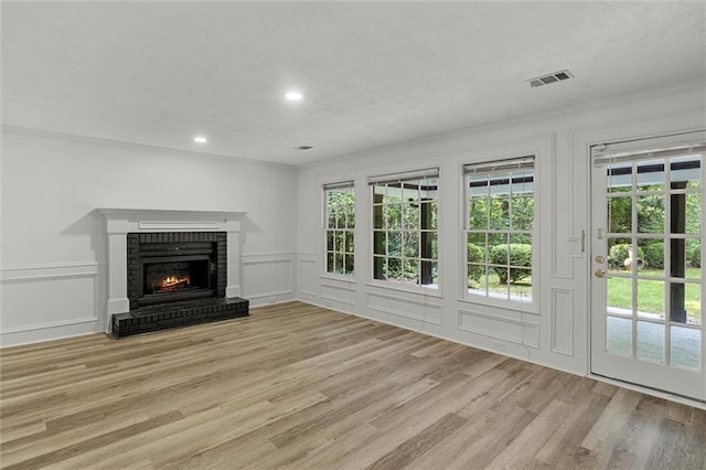 4220 Singing Post Ln NE, Roswell, GA 30075 - unfurnished living room with a decorative wall, a fireplace, light wood finished floors, and recessed lighting