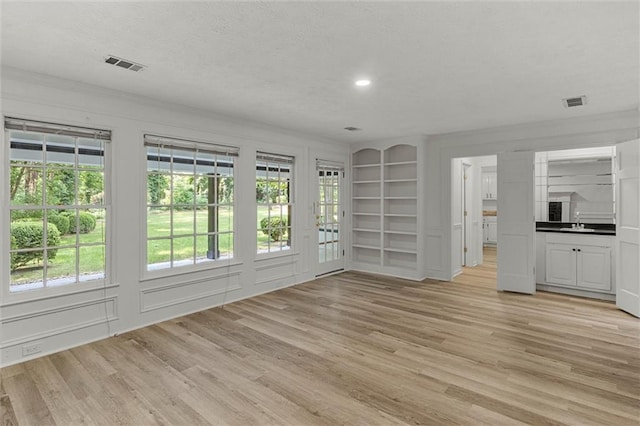 4220 Singing Post Ln NE, Roswell, GA 30075 - unfurnished living room featuring a sink, light wood finished floors, recessed lighting, and built in features