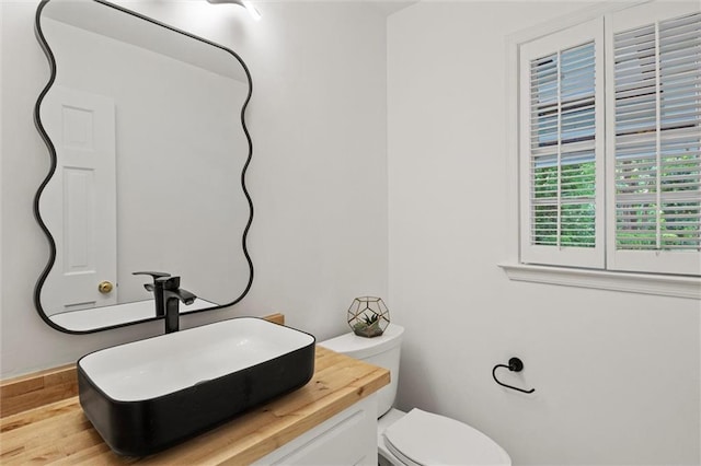 4220 Singing Post Ln NE, Roswell, GA 30075 - bathroom featuring toilet, vanity, and wood finished floors