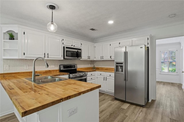 4220 Singing Post Ln NE, Roswell, GA 30075 - kitchen with appliances with stainless steel finishes, a sink, wood counters, open shelves, and a peninsula