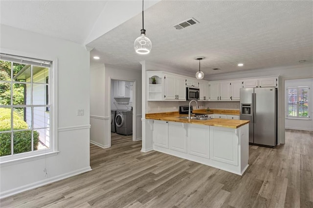 4220 Singing Post Ln NE, Roswell, GA 30075 - kitchen featuring appliances with stainless steel finishes, wood counters, open shelves, light wood-type flooring, and white cabinets