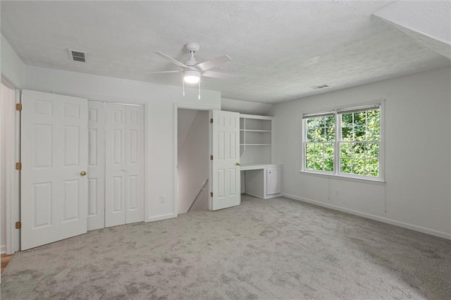 4220 Singing Post Ln NE, Roswell, GA 30075 - unfurnished bedroom featuring baseboards, carpet, a textured ceiling, and a ceiling fan