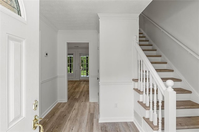 4220 Singing Post Ln NE, Roswell, GA 30075 - staircase with wood finished floors, a textured ceiling, and crown molding