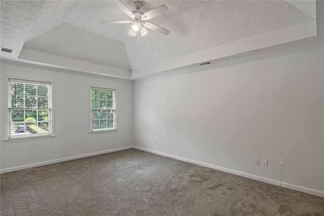 4220 Singing Post Ln NE, Roswell, GA 30075 - spare room featuring a tray ceiling, carpet floors, a textured ceiling, and baseboards