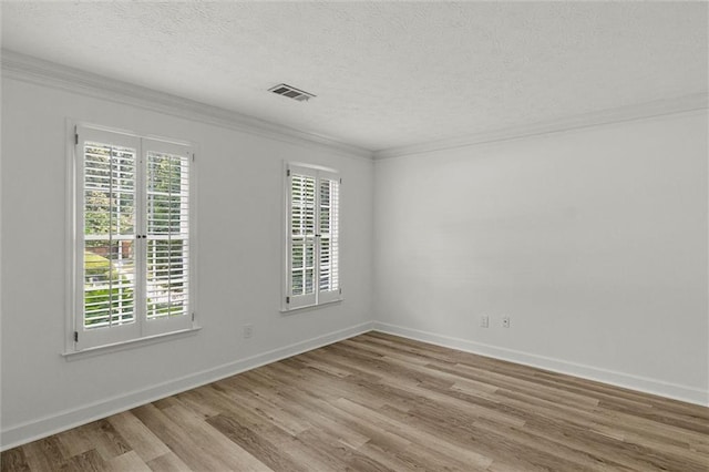 4220 Singing Post Ln NE, Roswell, GA 30075 - unfurnished room featuring crown molding, wood finished floors, a textured ceiling, and baseboards