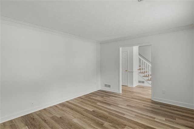 4220 Singing Post Ln NE, Roswell, GA 30075 - spare room with crown molding, stairway, wood finished floors, and baseboards