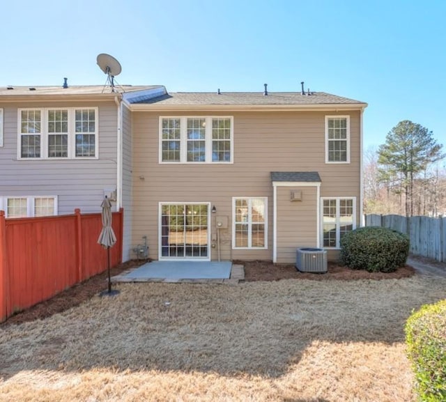 rear view of house with a patio area, a fenced backyard, and cooling unit