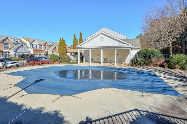 pool featuring a residential view, fence, and a patio