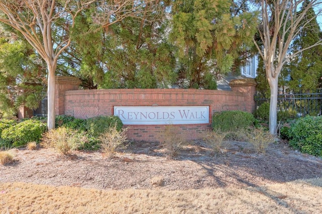 community sign featuring fence