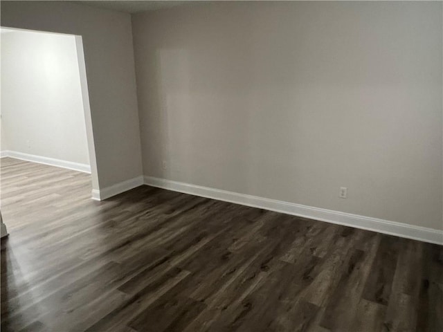 empty room with dark hardwood / wood-style floors