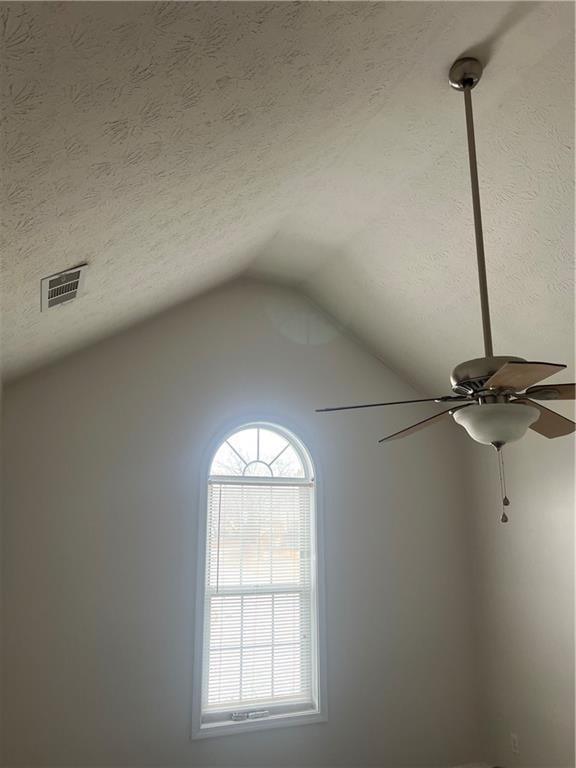 interior details with ceiling fan and a textured ceiling