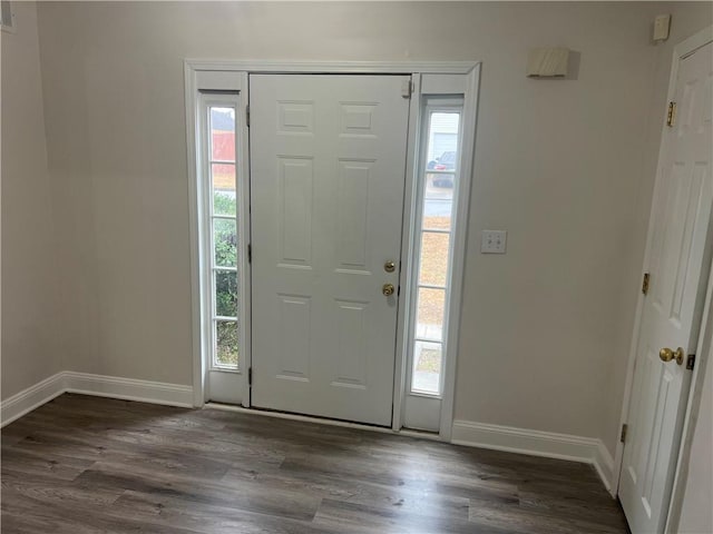 entrance foyer featuring dark wood-type flooring, visible vents, and baseboards