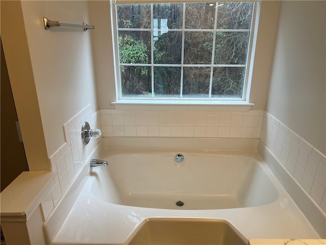 bathroom with a tub to relax in