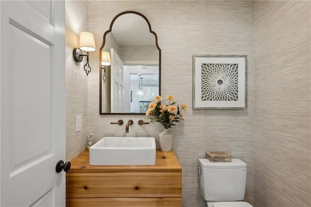 bathroom featuring tile walls, toilet, and vanity