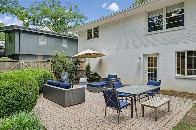 view of patio / terrace featuring fence, an outdoor living space, and outdoor dining space