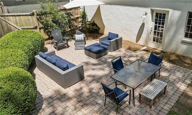 view of patio / terrace with an outdoor hangout area, fence, and outdoor dining area
