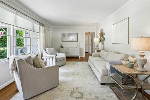 living room with ornamental molding, wood finished floors, and baseboards