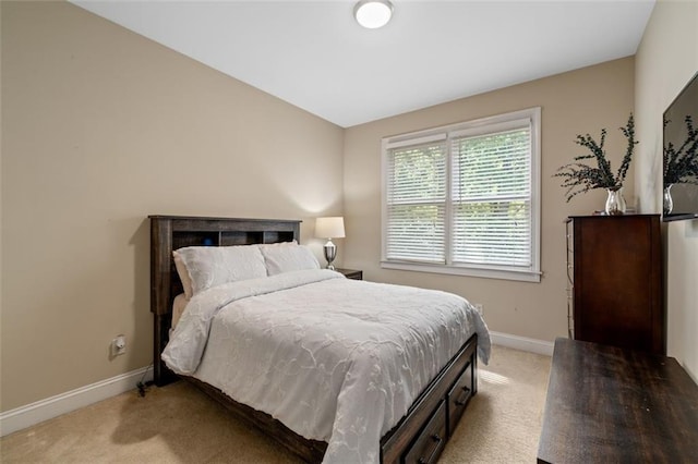 bedroom featuring light colored carpet and baseboards