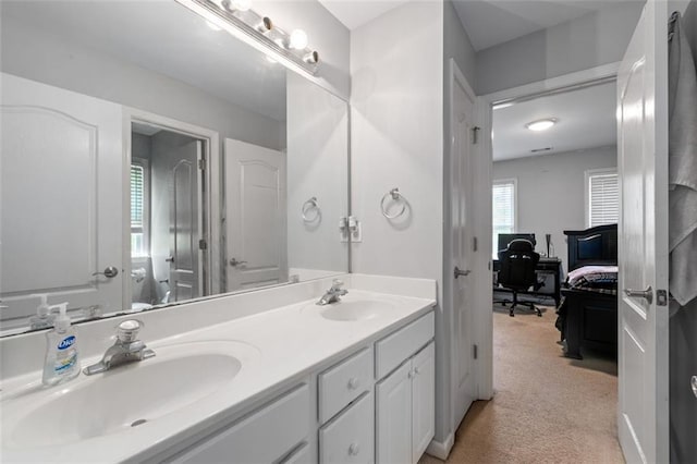 bathroom with connected bathroom and double vanity