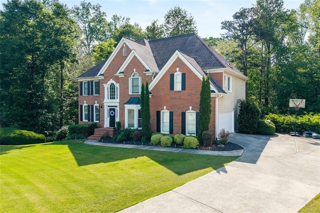 colonial-style house with concrete driveway, an attached garage, brick siding, and a front lawn
